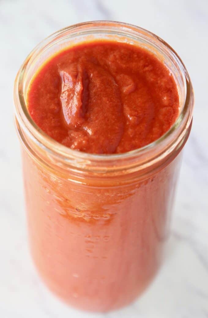 red enchilada sauce in tall mason jar