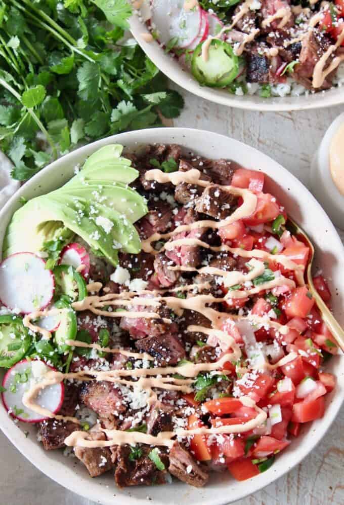 carne asada bowl with chipotle crema drizzle on top