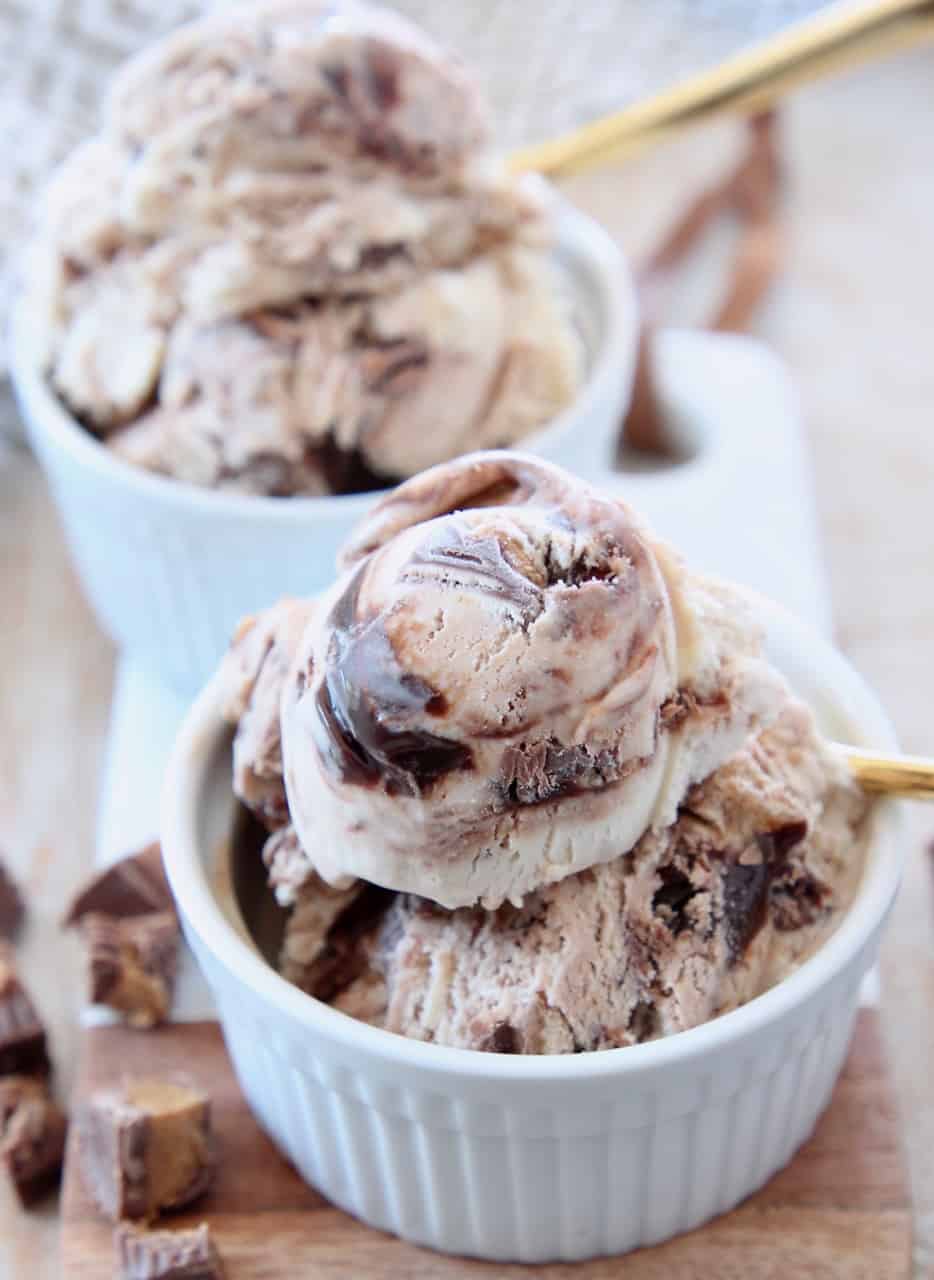 scoops of ice cream in white bowl with gold spoon