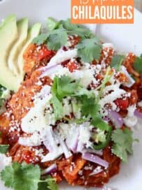 chilaquiles on plate topped with cilantro and red onion