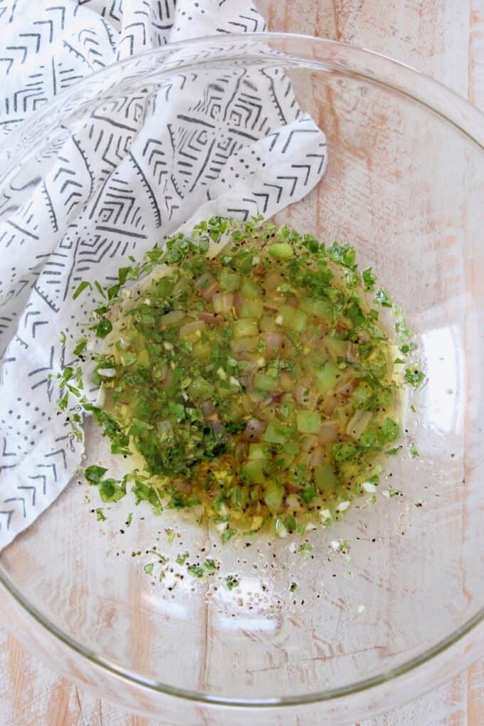 lemon herb dressing with sauteed vegetables in glass bowl