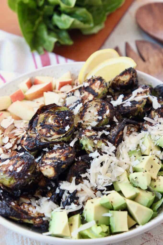 grilled brussels sprouts salad in bowl with diced avocado