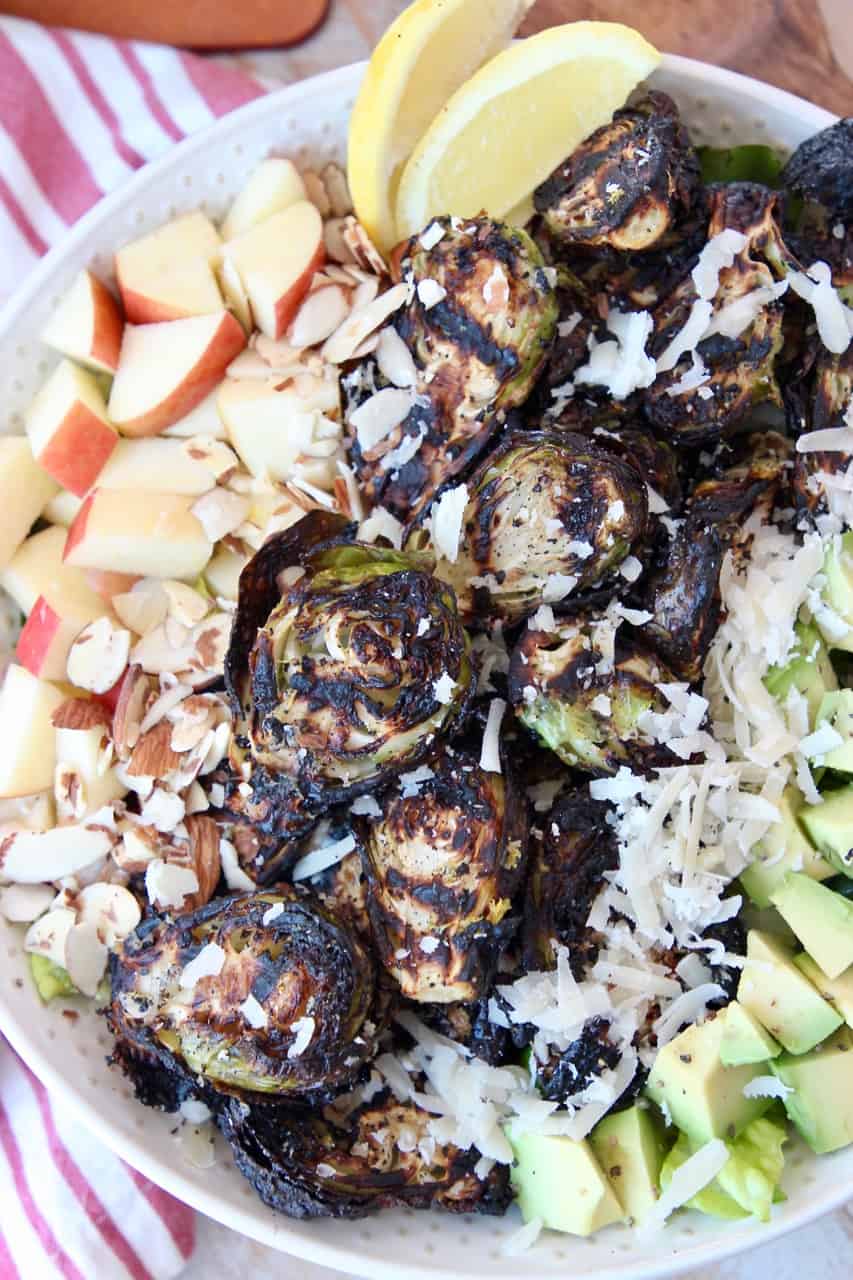 grilled brussels sprouts in bowl with salad