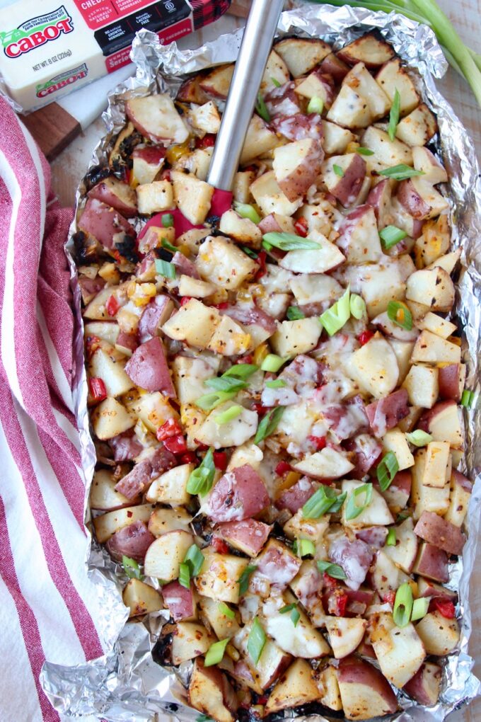 grilled diced potatoes in foil with spatula