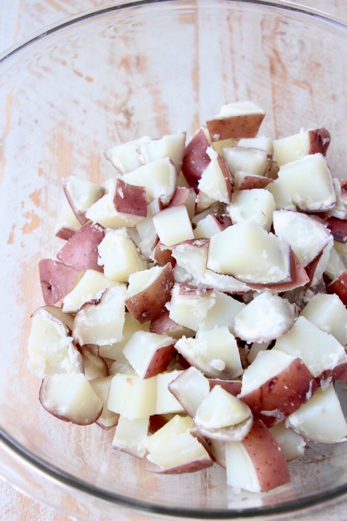 boiled, cubed red potatoes in a large glass bowl