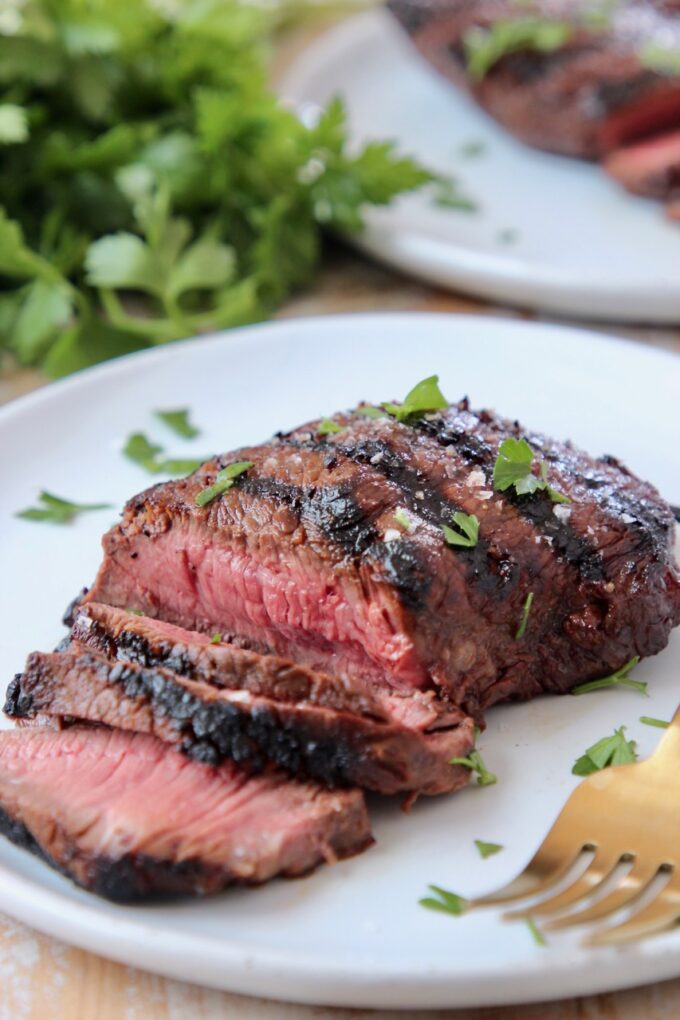 sliced sirloin steak on plate with fork