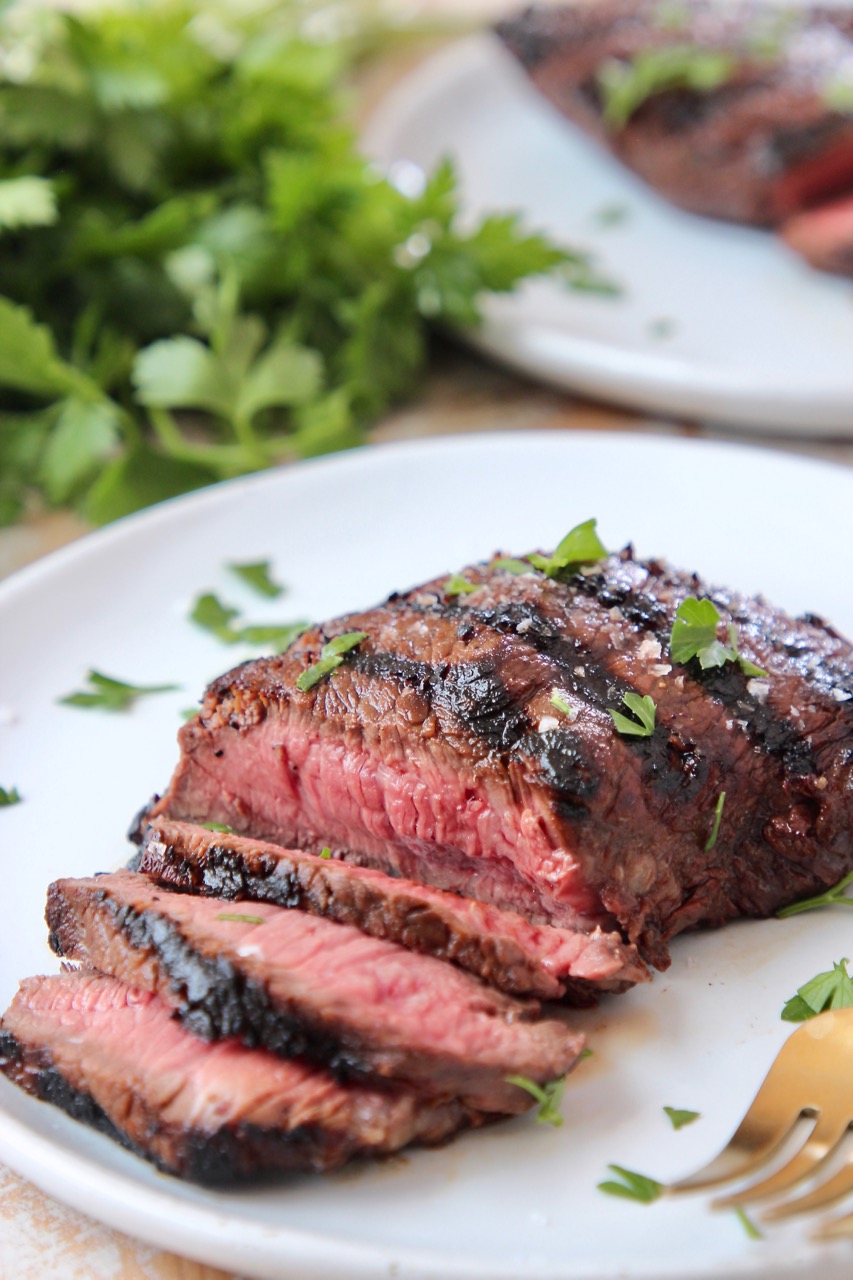 sliced grilled sirloin steak on white plate