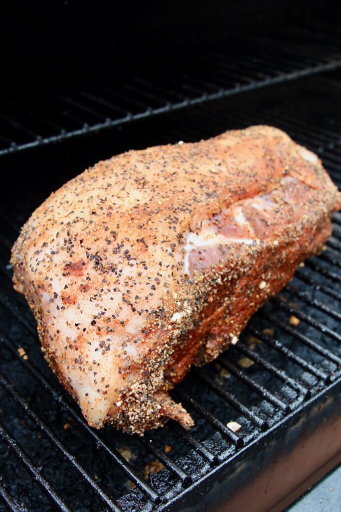 spice rubbed pork shoulder on a smoker