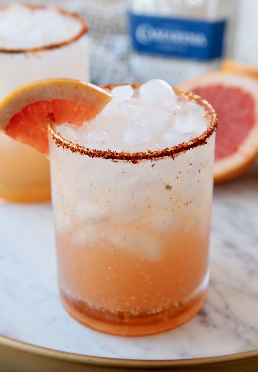 paloma cocktail in glass with tajin rim