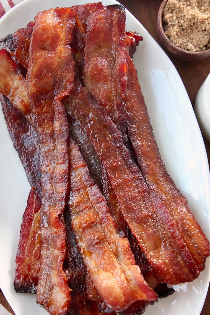 slices of cooked bacon on top of each other on white plate