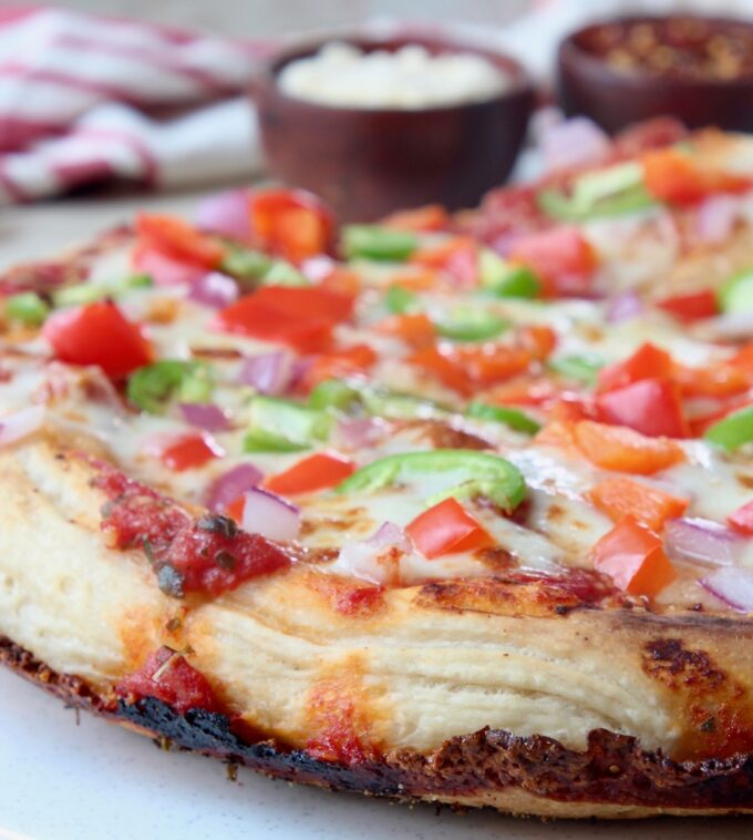 cooked pan pizza with crispy cheese crust and vegetable toppings