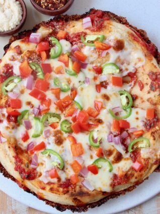 overhead image of cooked pizza on marble serving tray