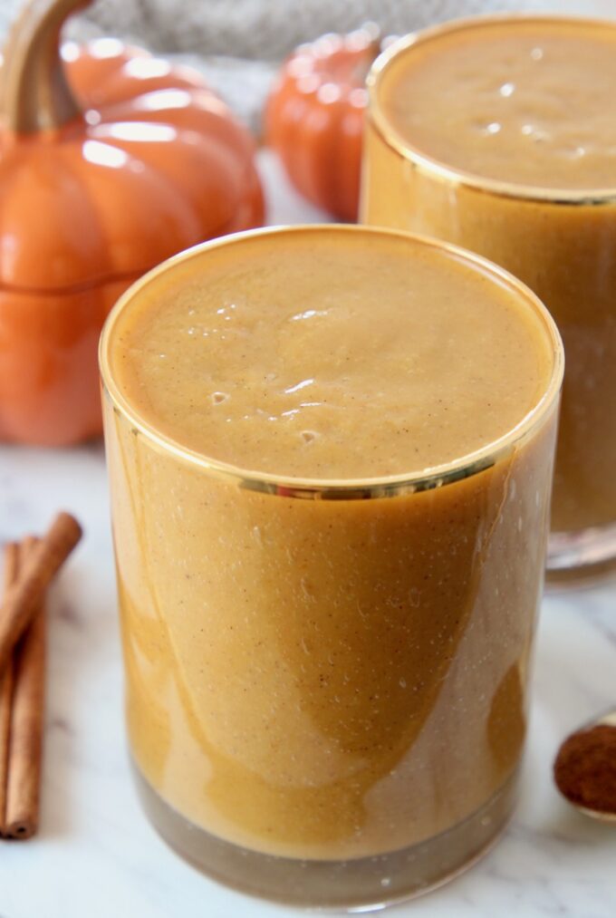pumpkin smoothie in glass with gold rim