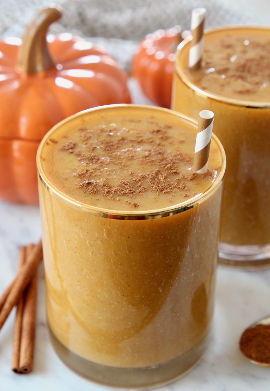 pumpkin smoothie in glass with straw