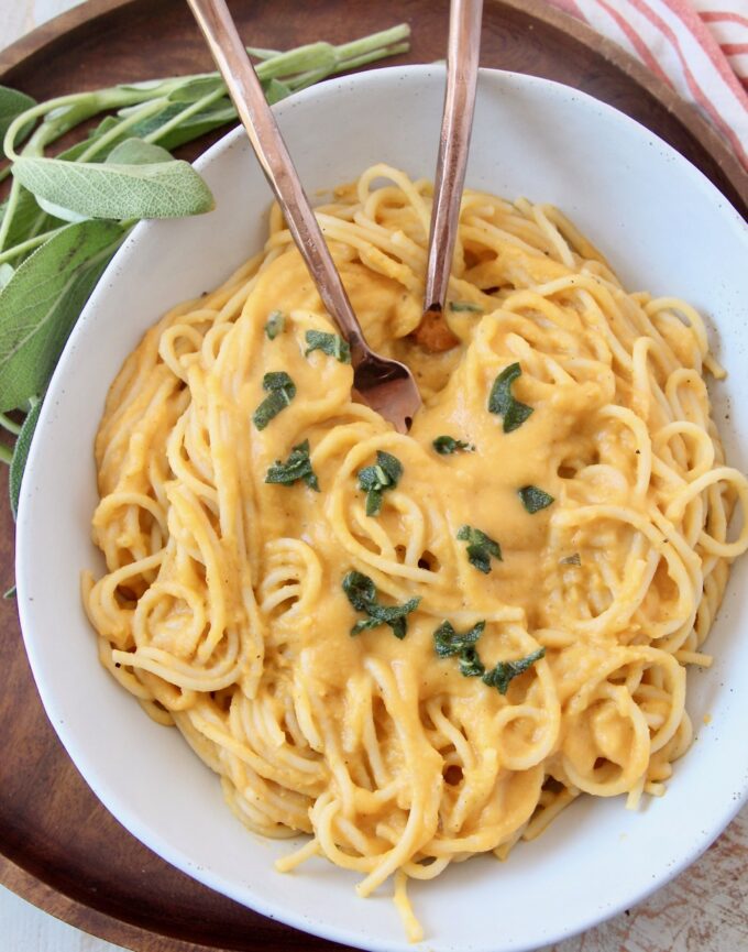 spaghetti noodles tossed with butternut squash sauce in bowl