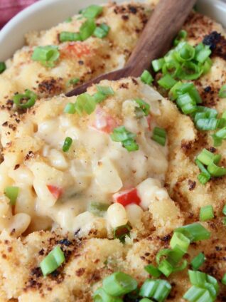 cajun macaroni and cheese in baking dish with serving spoon