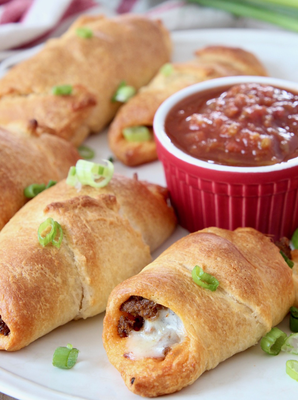 taco crescent rolls on plate with small bowl of salsa