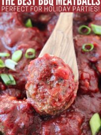 bbq meatballs in bowl with wooden spoon topped with diced green onions