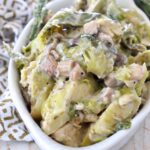 cooked brussel sprout casserole in white serving bowl
