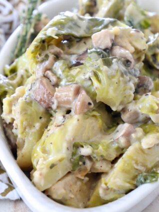 cooked brussel sprout casserole in white serving bowl