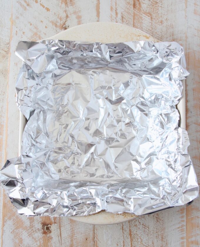 a piece of foil pressed into a square baking dish