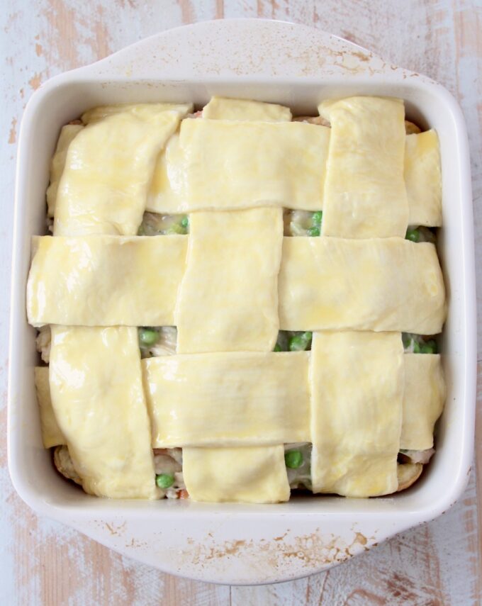 woven puff pastry crust over a pot pie in a square baking dish