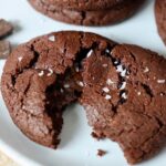 chocolate cookie topped with sea salt on plate