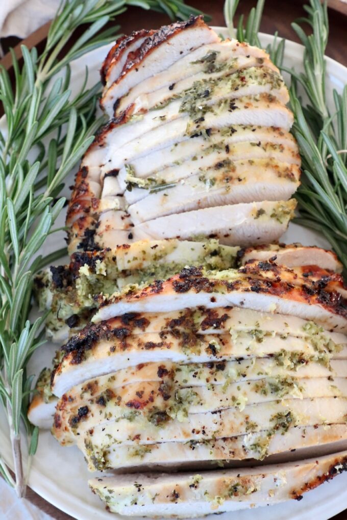slices of turkey breast on plate with fresh herbs