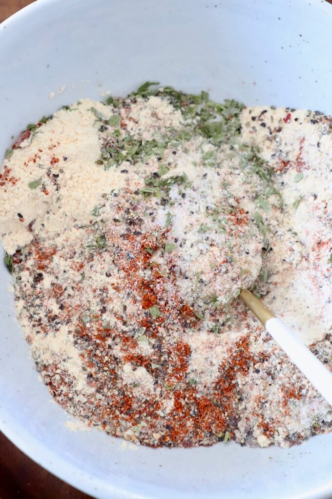 chicken seasoning mixed together in white bowl with spoon