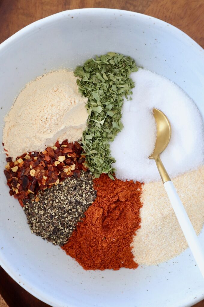 spices for chicken seasoning in bowl with gold spoon