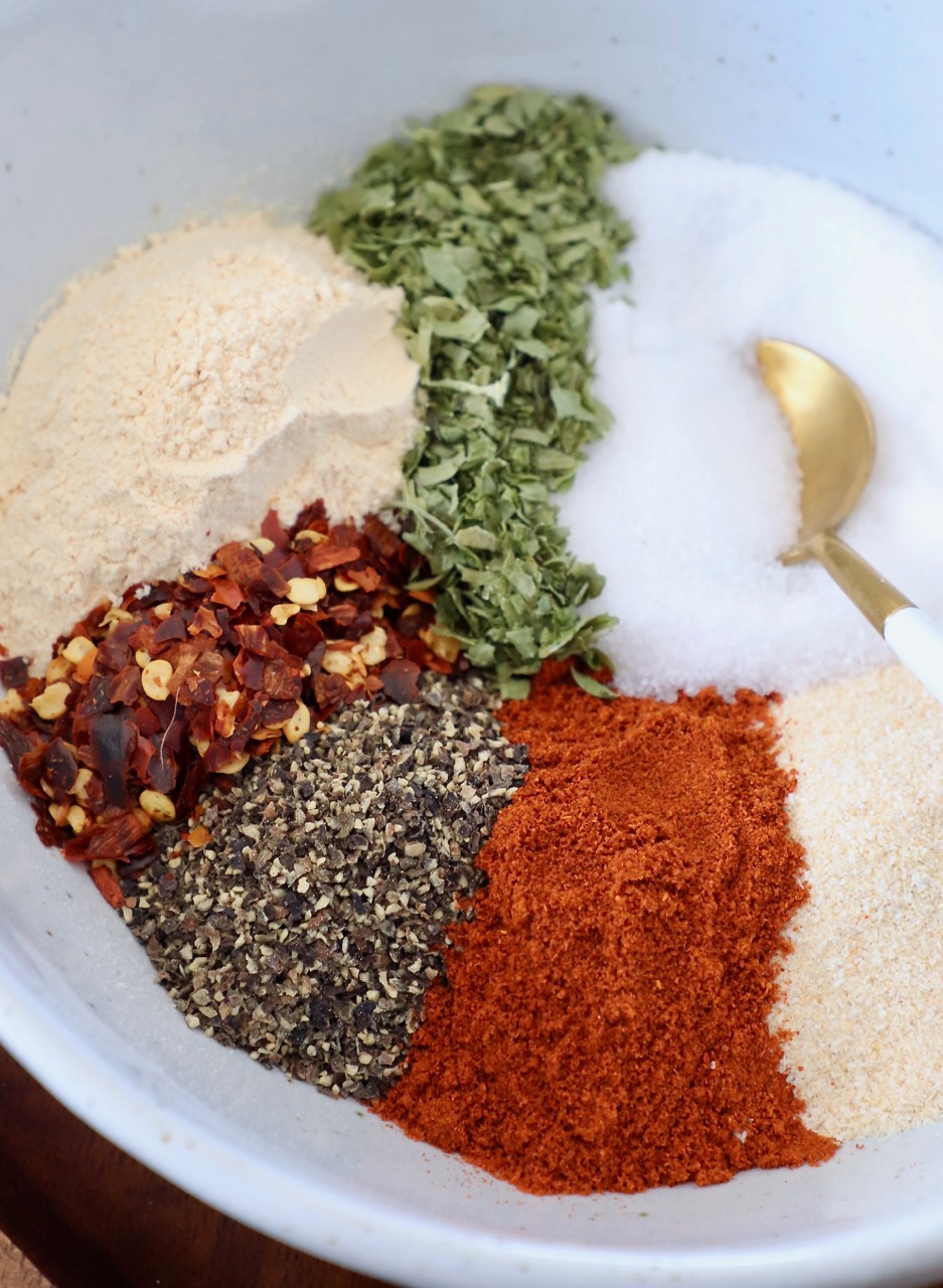 spices in bowl with gold spoon