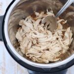 shredded chicken in instant pot with large serving fork
