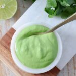 cilantro lime sauce in bowl with spoon