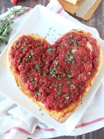 heart shaped pizza on white plate