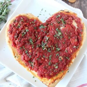 heart shaped pizza on white plate