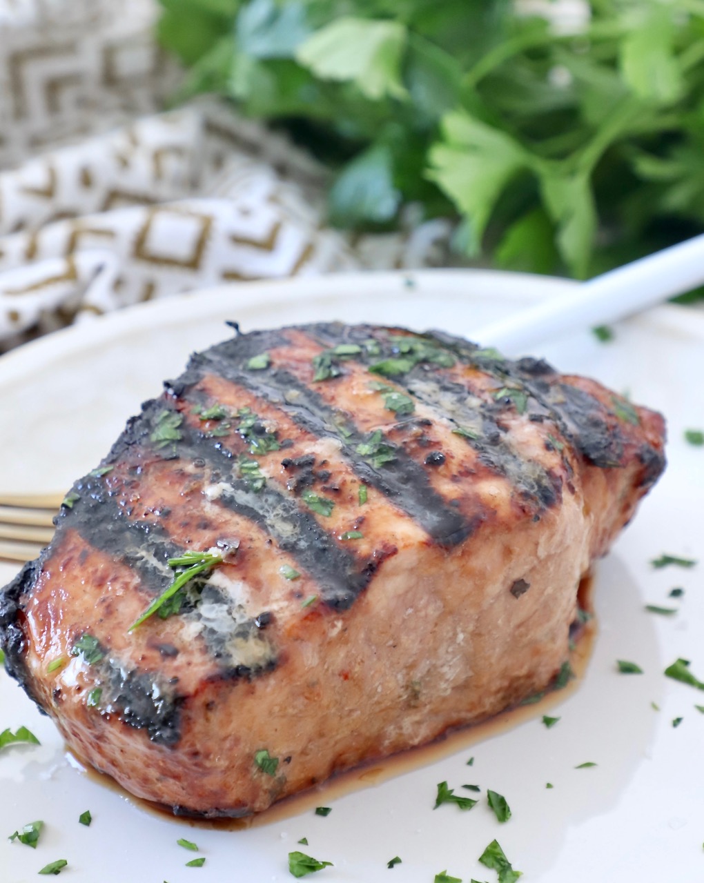 grilled pork chop on plate with fork