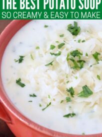 potato soup in bowl topped with shredded swiss cheese and chopped parsley
