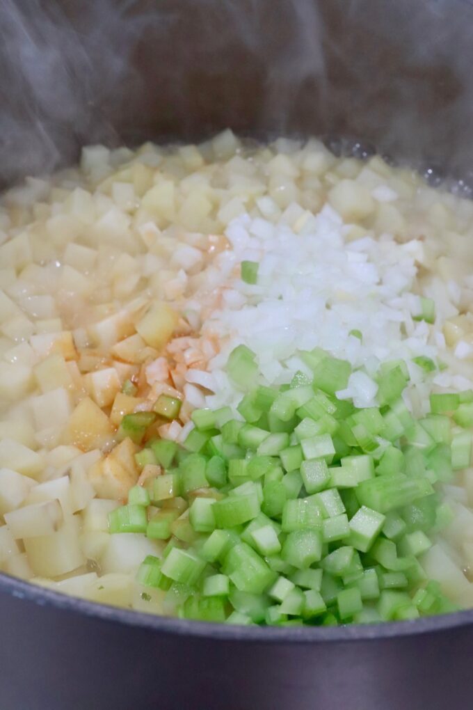 diced potatoes, onions and celery in a large pot with liquid