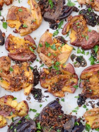 garlic herb baked smashed baby potatoes on baking sheet