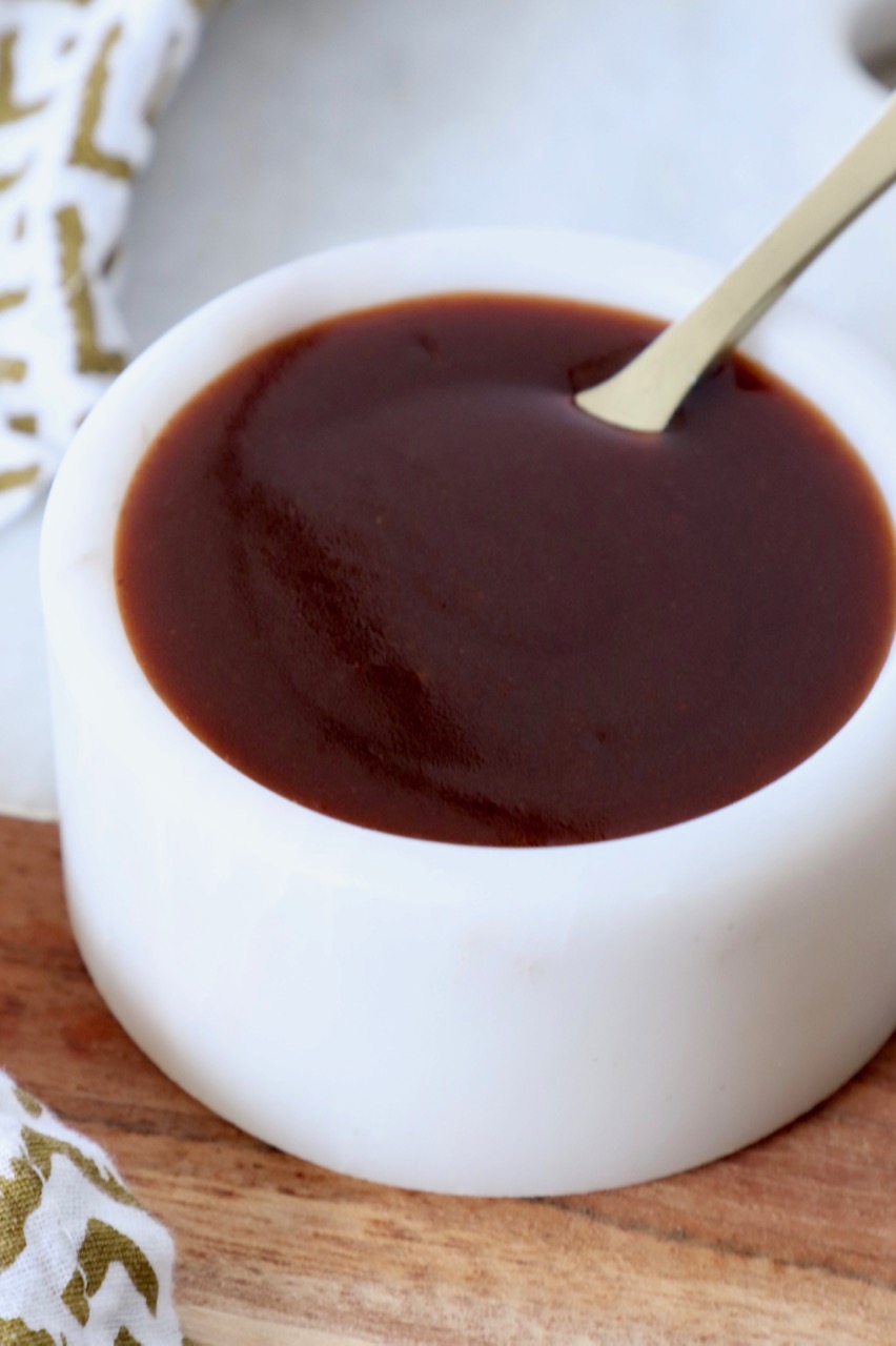 stir fry sauce in white bowl with small spoon