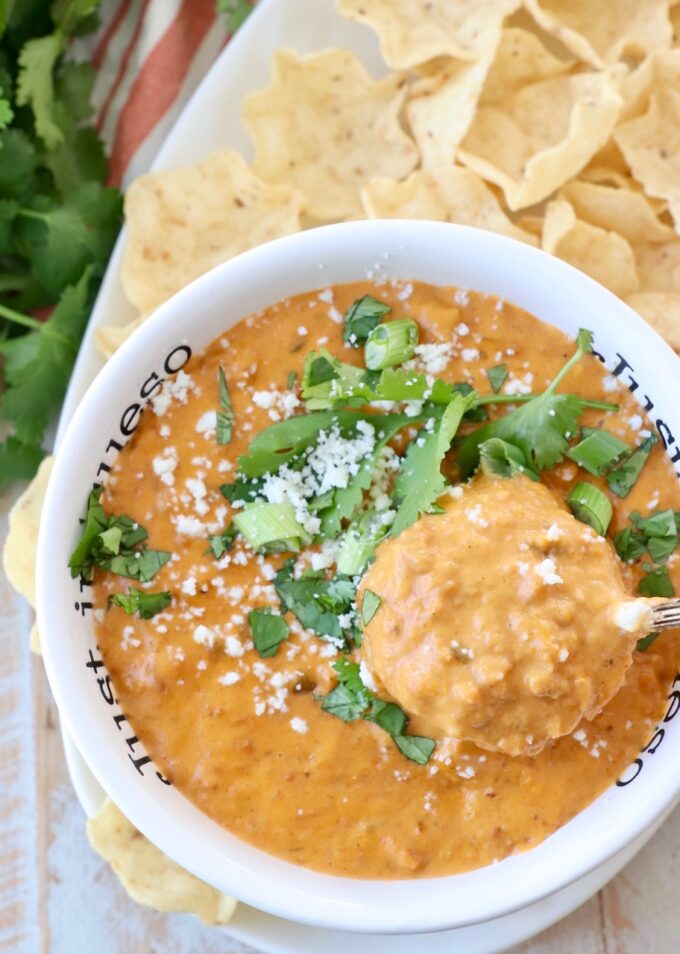 chorizo queso dip in bowl with spoon dipped into the queso