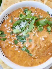 chorizo queso dip in bowl topped with fresh chopped cilantro