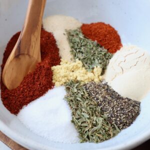 herbs and spices in white bowl with spoon