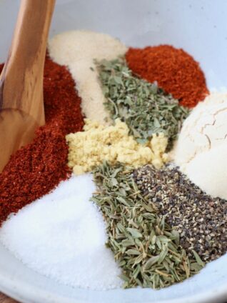 herbs and spices in white bowl with spoon