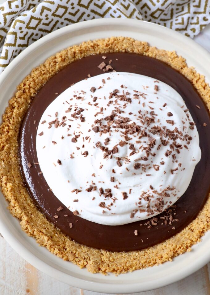 chocolate pie topped with whipped cream and chocolate shavings