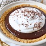 chocolate pie topped with whipped cream in pie plate
