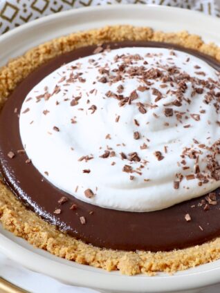 chocolate pie topped with whipped cream in pie plate