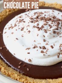 chocolate pie topped with whipped cream and chocolate shavings