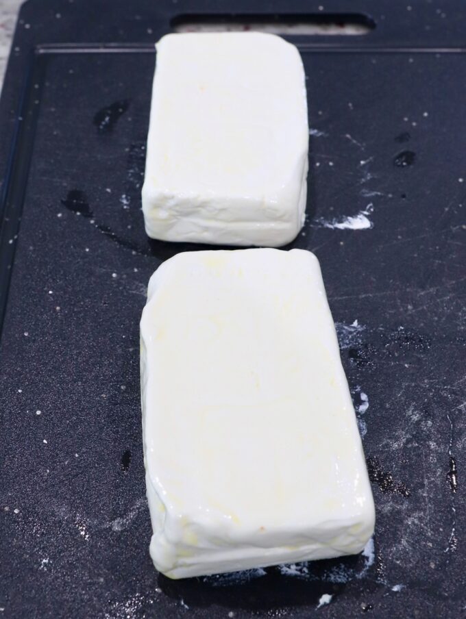 blocks of cream cheese on cutting board