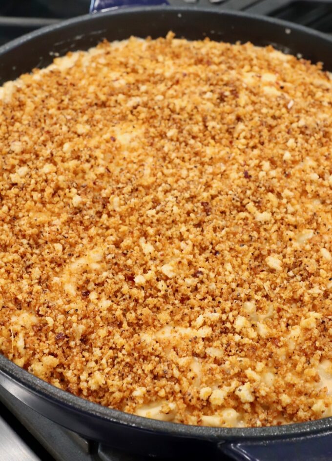 mac and cheese in skillet with panko breadcrumb topping